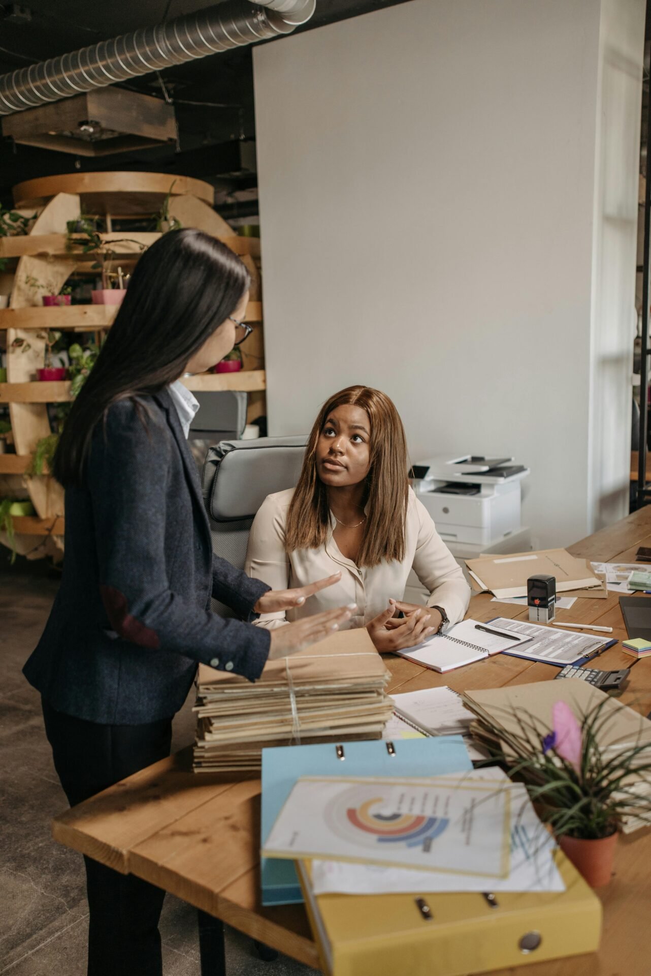 Business professionals collaborate on documents in a modern office setting.